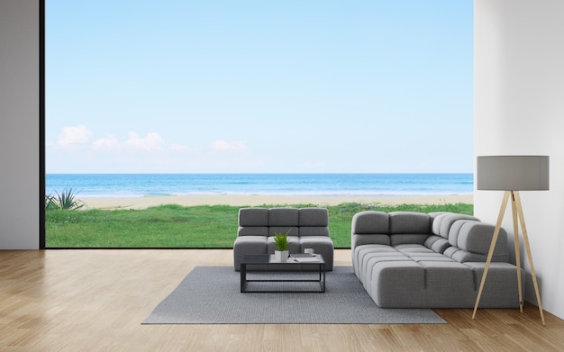 Sofá en el piso de madera de una sala de estar en una casa moderna con vistas al cielo y al mar