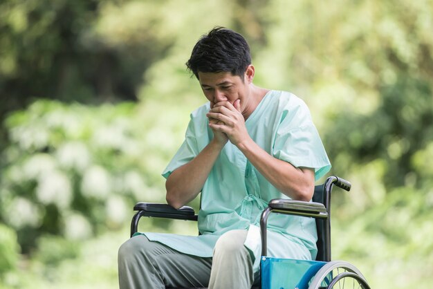 Solo joven discapacitado en silla de ruedas en el jardín