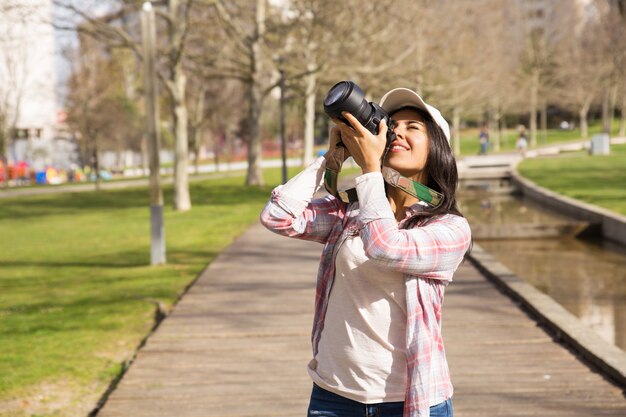 Sonriendo emocionado turista disparando hito