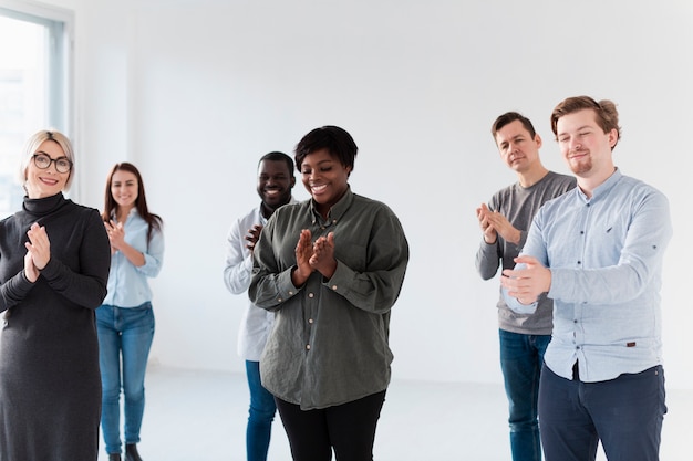 Sonriendo pacientes masculinos y femeninos aplaudiendo