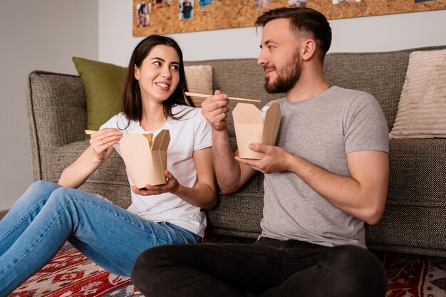 Sonriente hombre y mujer almorzando juntos en casa