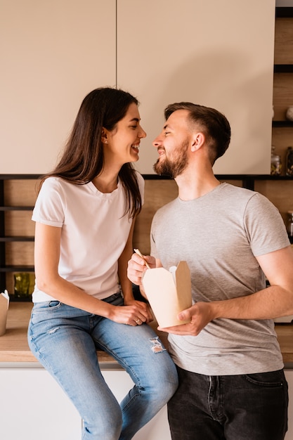 Sonriente hombre y mujer almorzando juntos en casa