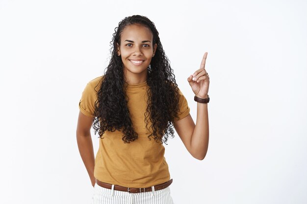 Sonriente niña afroamericana en camiseta marrón