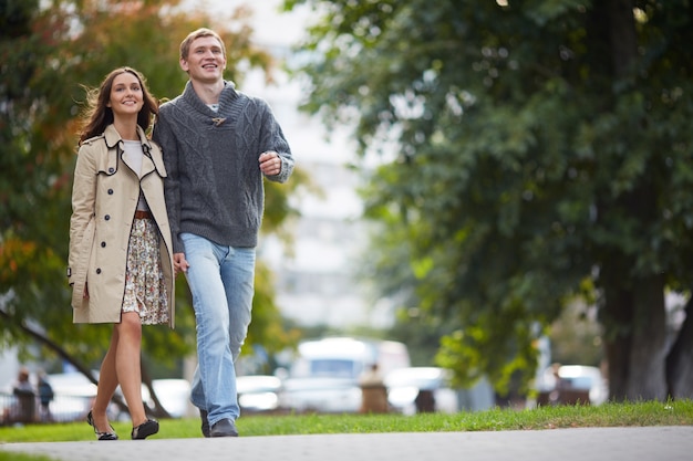 Sonriente pareja dando un paseo al aire libre