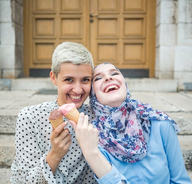 Sonrientes amigos comiendo helado