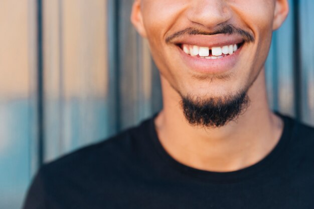 Sonrisa de hombre de etnia con bigote y barba.