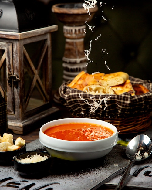 Sopa crema de tomate con queso rallado y galletas