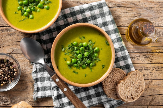 Sopa de guisantes verdes en un bol sobre una mesa de madera rústica Vista superior