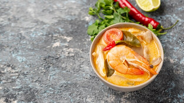 Sopas de alto ángulo en tazones con camarones, limón y pimienta con espacio de copia