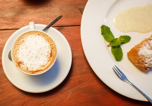 Foto gratuita strudel de manzana con salsa y café