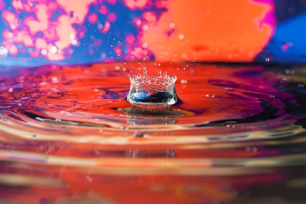 Superficie de agua con ondas y fondo de colores