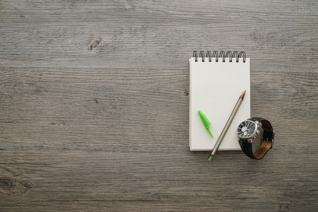 Superficie de madera con bolígrafo y cuaderno para el día del padre