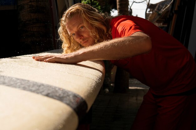 El surfista lava su tabla con agua. bali