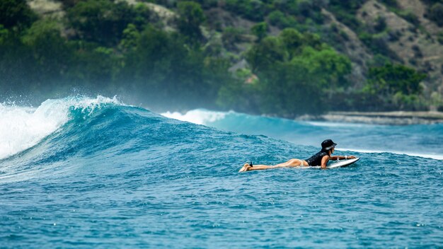 Surfista en una ola azul.