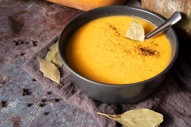 Surtido de alto ángulo con sopa de calabaza en un tazón