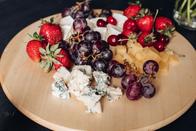 Surtido de fruta y plato de queso. Primer plano de plato de comida deliciosa