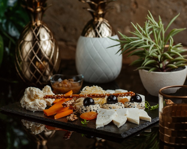 Tabla de quesos con amplia selección de alimentos.