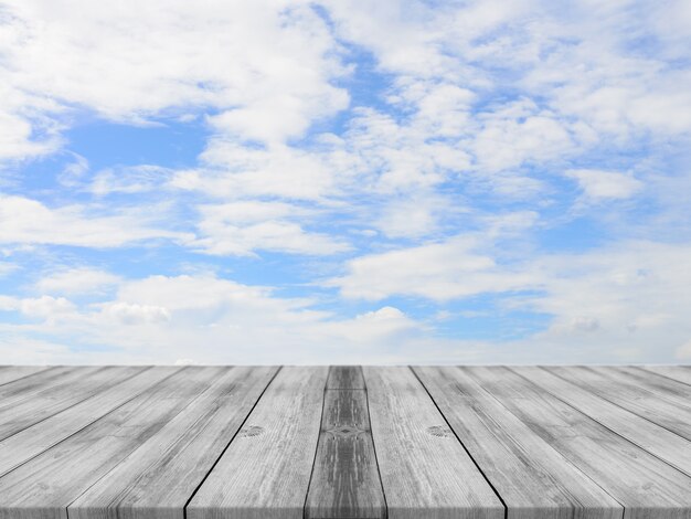 Tablas de madera con un cielo con nubes de fondo