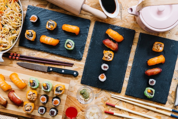 Tableros con sushi en la mesa de madera