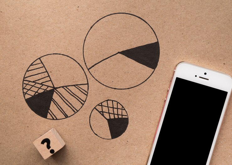 Photo Gratis tampilan atas ponsel cerdas di sebelah grafik