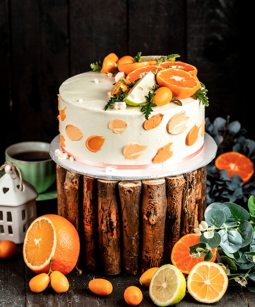 Foto gratuita tarta con crema blanca decorada con lima y naranja