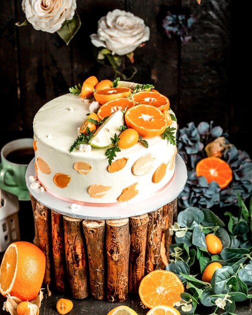 Tarta con crema blanca decorada con lima y naranja