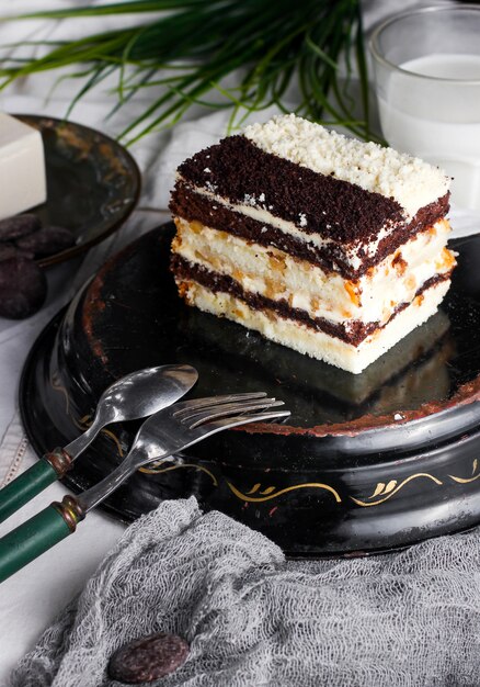 Tarta diurna y nocturna con crema y nuez decorada con trozos de tarta marrón y blanca