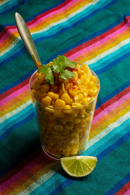 Foto gratuita taza de alto ángulo con deliciosos esquites.