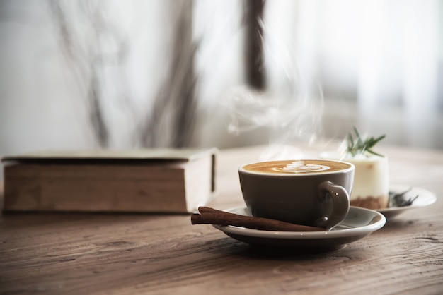 Taza de café caliente en mesa de madera