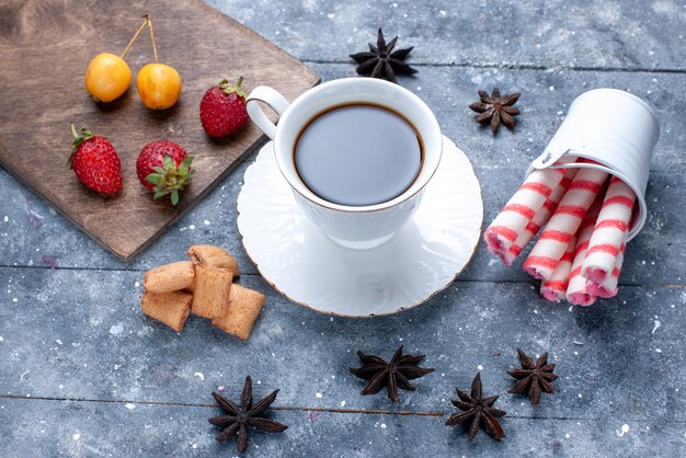 Taza de café con fresas rojas, galletas, caramelos de palo rosa en un escritorio brillante, galletas de café, galletas, baya