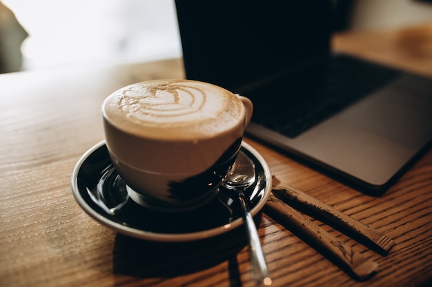 Foto gratuita taza de café en la mesa del portátil