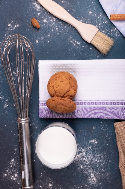 Foto gratuita taza de leche con galletas y pincel