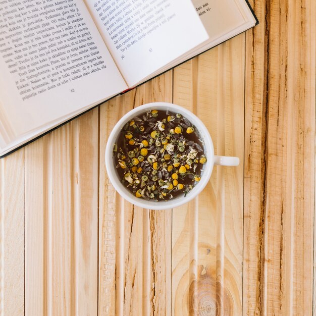 Taza de té de manzanilla y libro