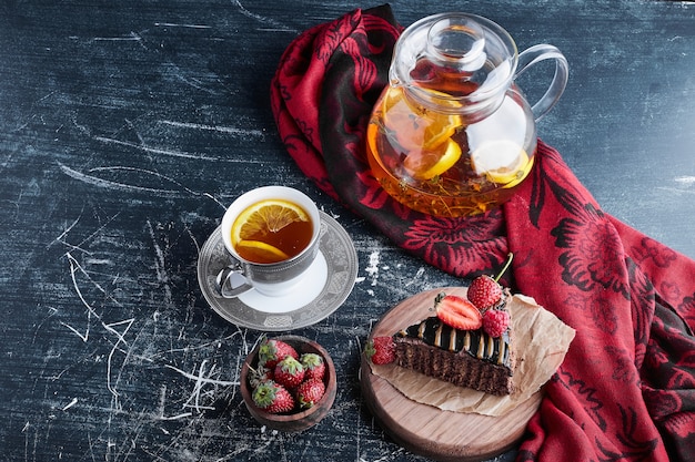 Una taza de té con tarta de limón y chocolate.
