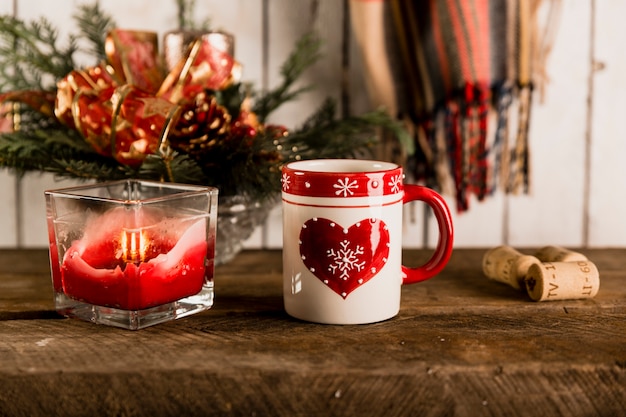 Taza y vela en la mesa de madera