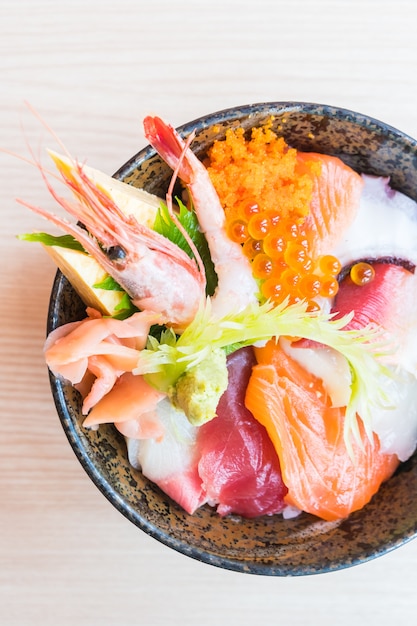 Tazón de arroz japonés con mariscos sashimi en la parte superior