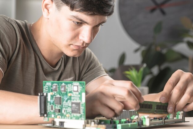 Se técnicos estudiantes que insertan RAM en la placa base de la computadora