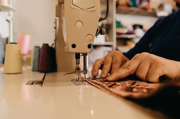 Tejer un trozo de alfombra en máquina de coser