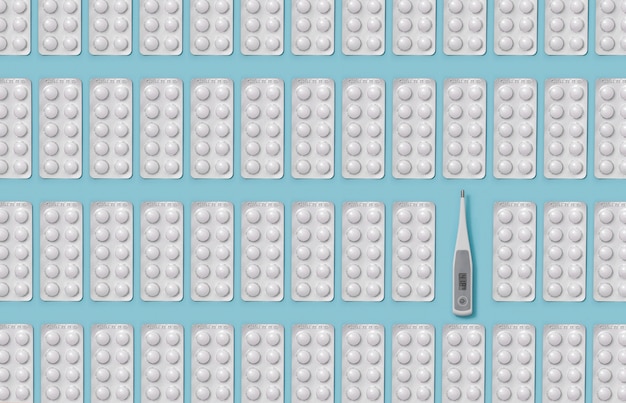 Termómetro con temperatura alta y pastillas.