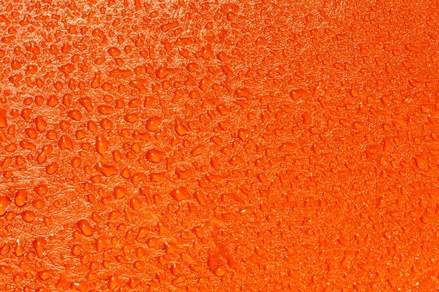 Textura naranja con gotas de agua