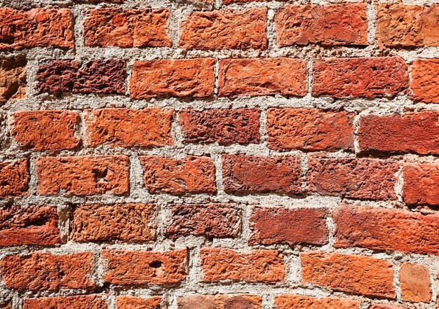 Textura de pared de ladrillo antiguo fondo grunge Pared de ladrillo rojo oscuro erosionada por el tiempo y textura de ladrillo natural Idea para banner publicitario o artículo de producto