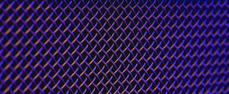 Foto gratuito textura de primer plano de una parrilla de metal de un altavoz de música en iluminación de colores