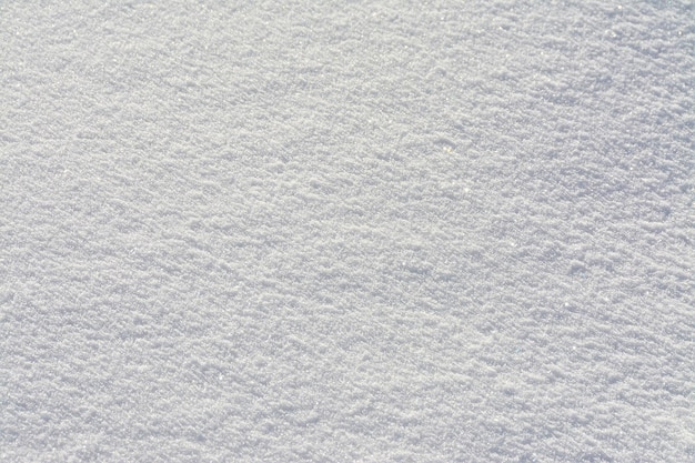 Textura de primer plano de la superficie de la nieve blanca fresca