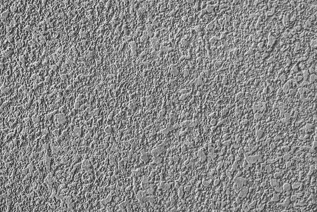 Textura rugosa de la pared enyesada de cemento gris