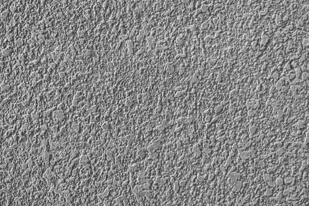 Textura rugosa de la pared enyesada de cemento gris