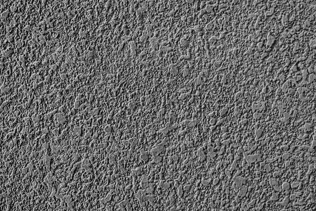 Textura rugosa de la pared enyesada de cemento gris