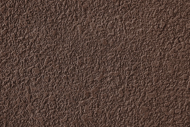 Textura rugosa de la pared enyesada de cemento marrón
