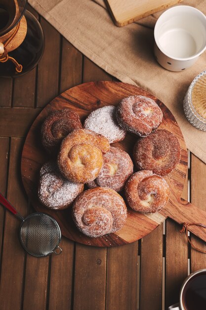 Tiro de alto ángulo de deliciosas rosquillas de serpiente recubiertas con azúcar en polvo