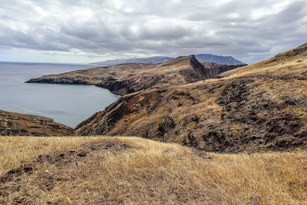 Tiro de ángulo alto de las colinas bajo el cielo nublado en Ponta do Sao Lourenco