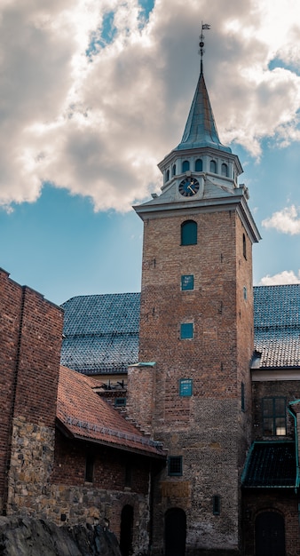 Tiro de ángulo bajo de la histórica fortaleza de Akershus bajo el hermoso cielo nublado en Oslo, Noruega